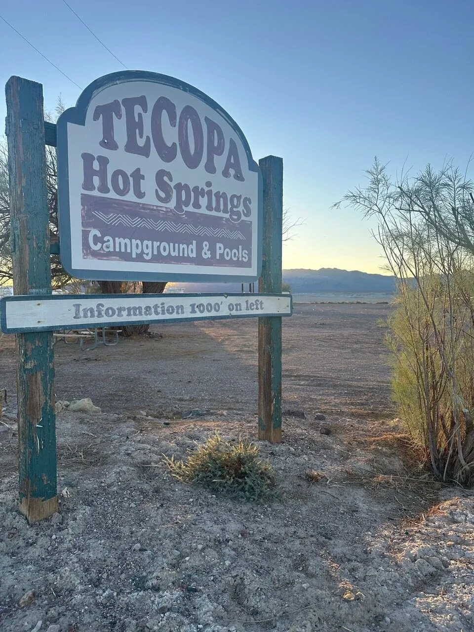 The weathered Tecopa Hot Springs Campground & Pools sign